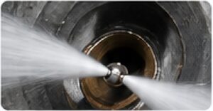 Professional drainage engineer repairing an outdoor drain system